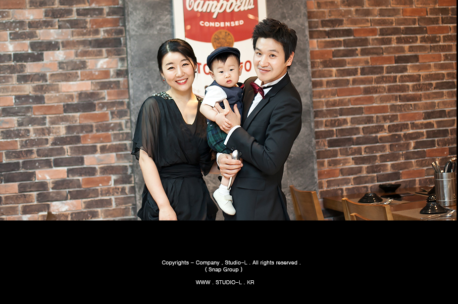 카페홀 Campbell 벽 앞, 아빠가 도혁이를 안고 선 가족 컷
